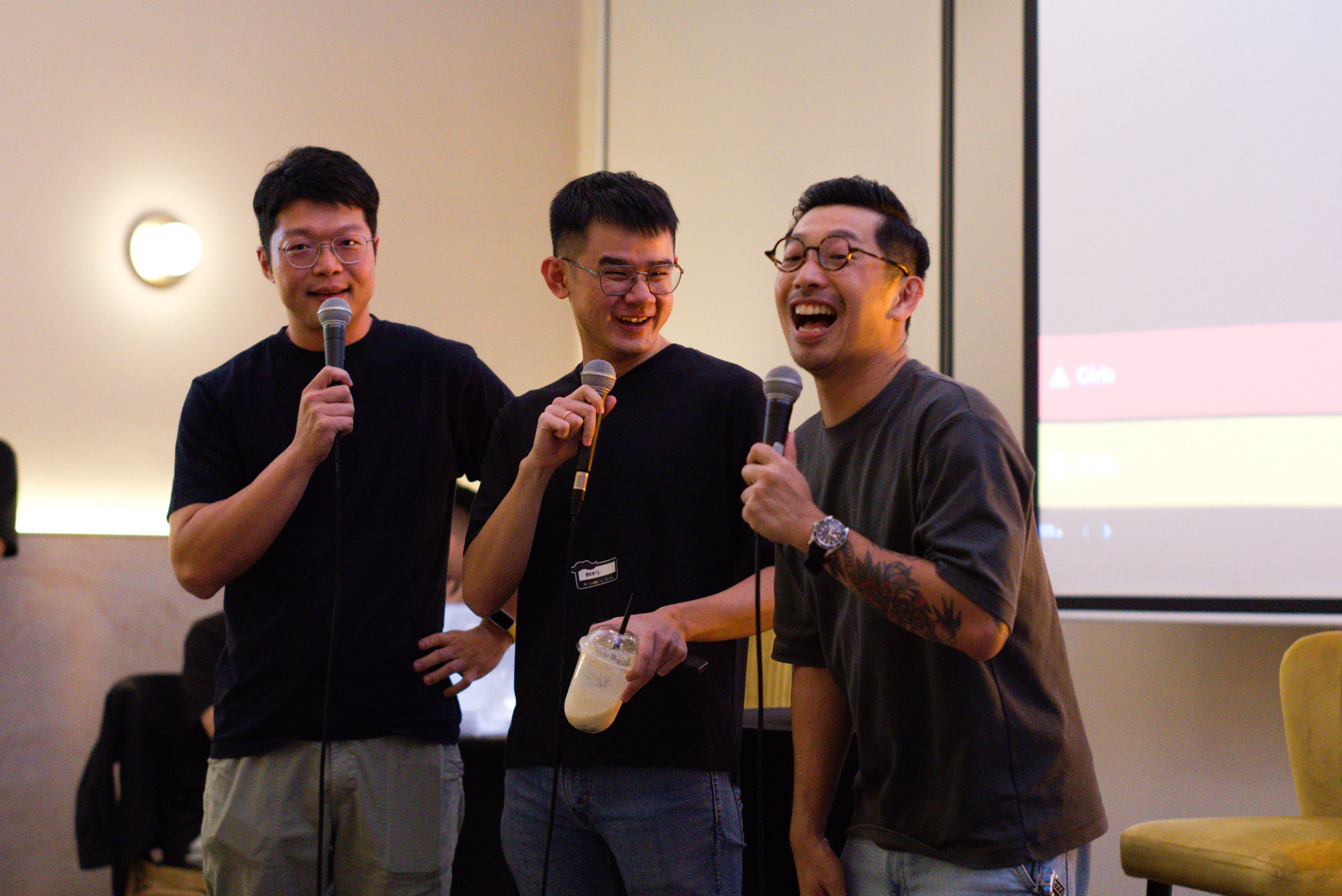 Two men answer a participants questions on stage