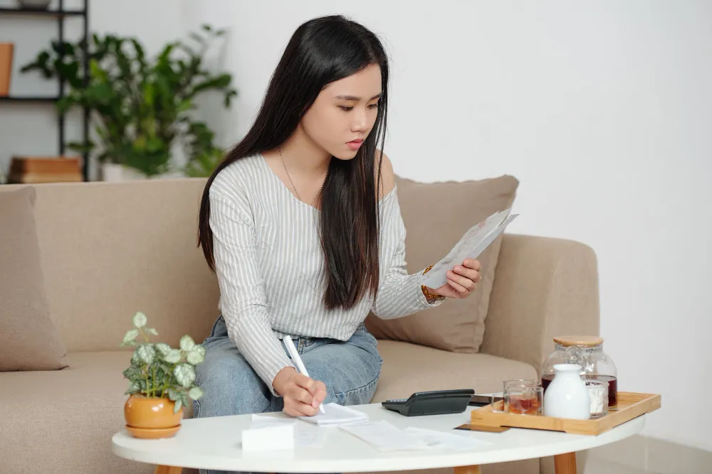 Woman listing down her expenses