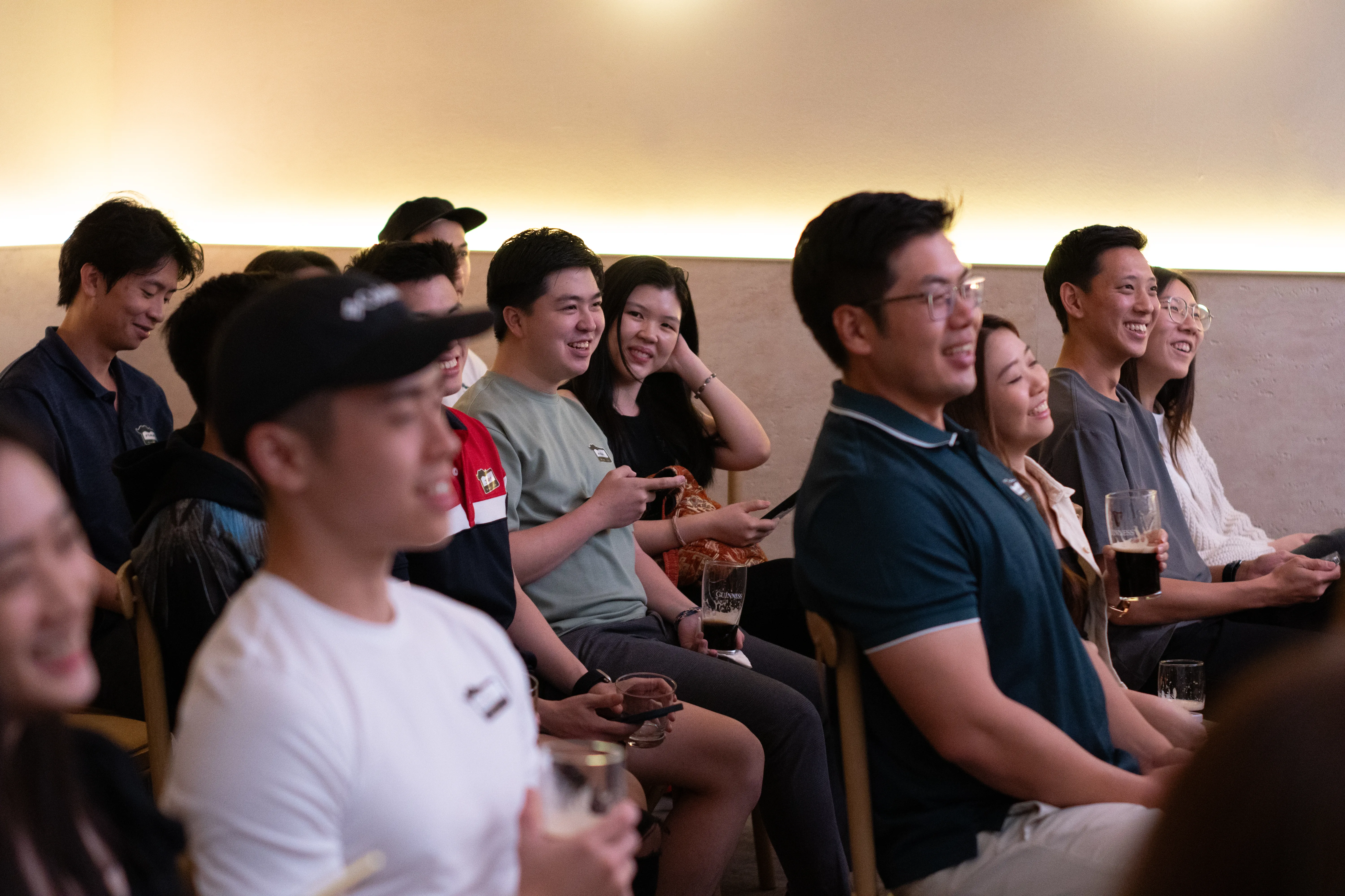 Audience members with a focus on a smiling woman