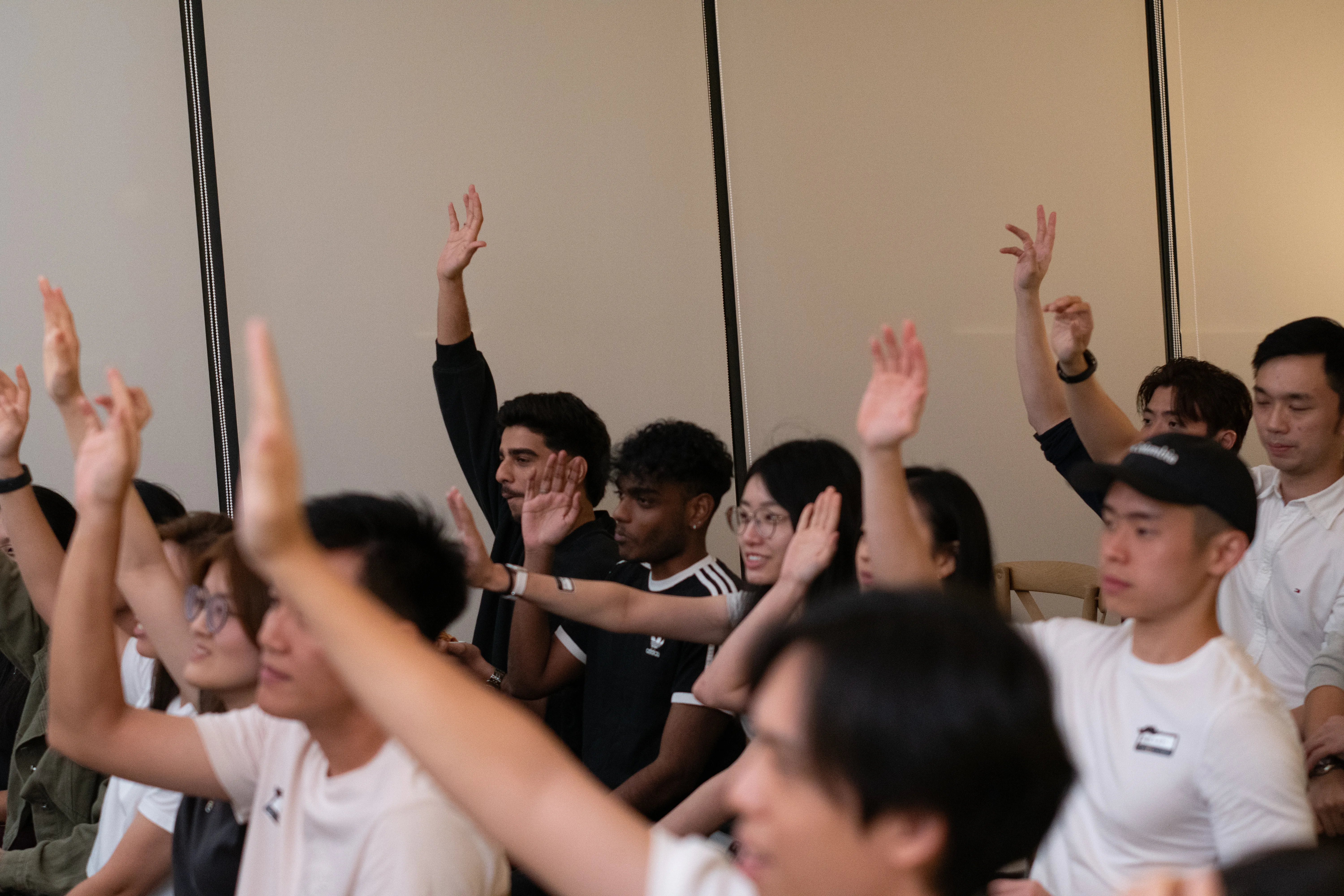 Audience members participating and raising their hands