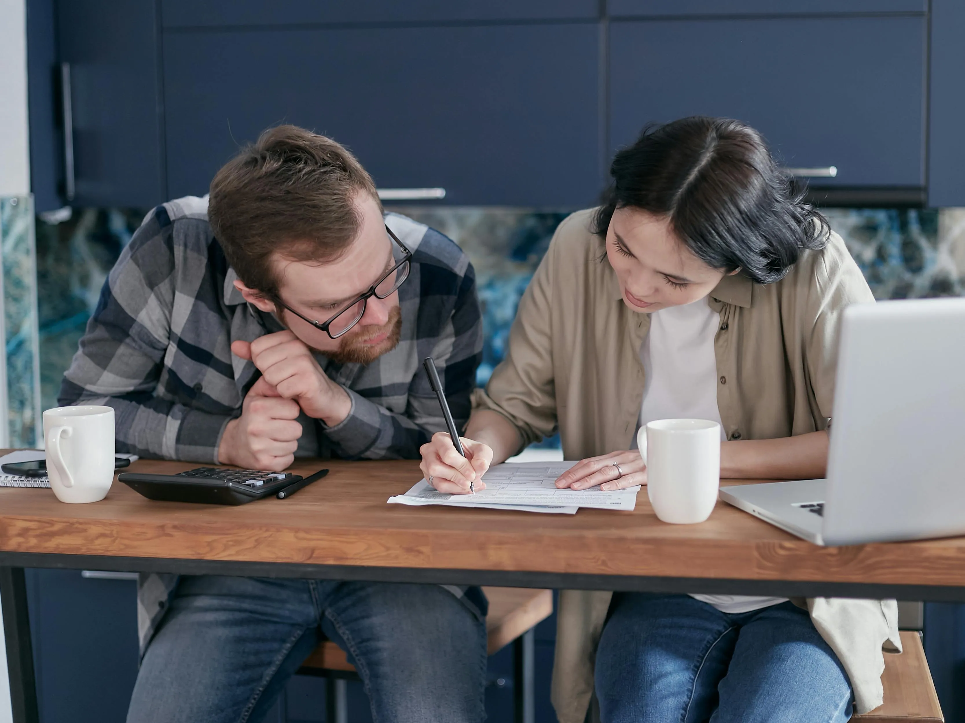 A couple listing down financial goals together