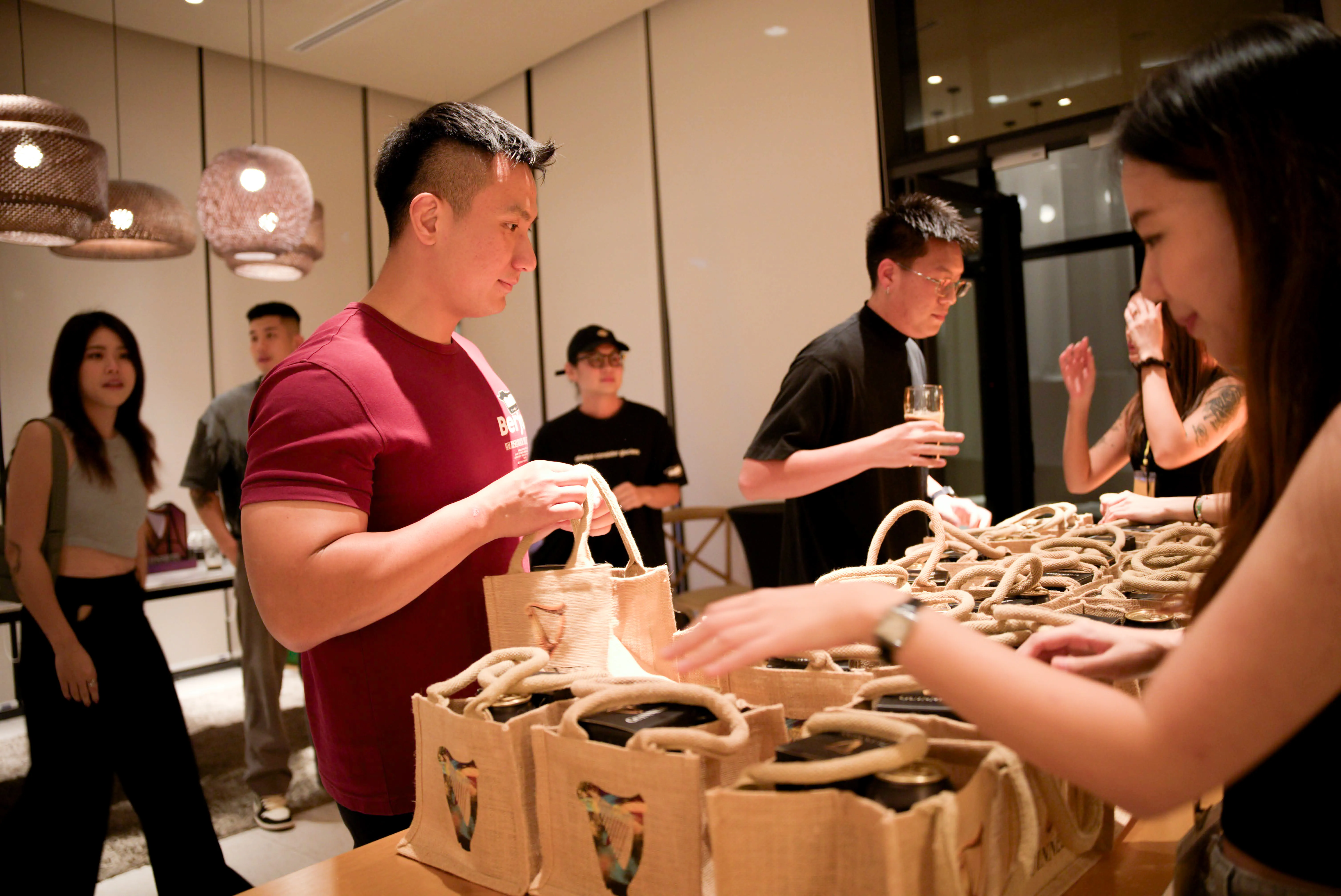 A man picking up his gift bag from the Guinness event